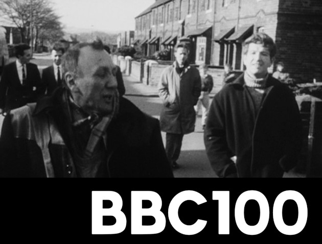 BBC 100 logo, with Nigel Barton walking with the road