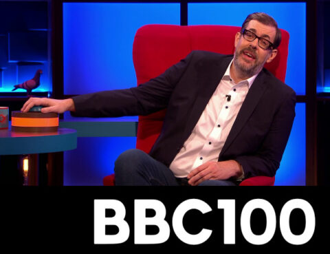 BBC100 logo with Richard Osman PUSHING a BUTTON