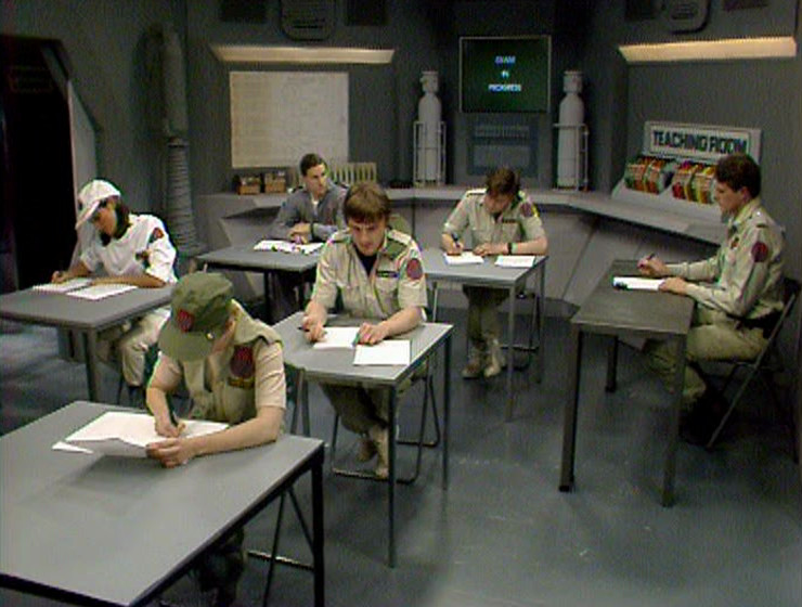Rimmer sitting in the Teaching Room for his exam