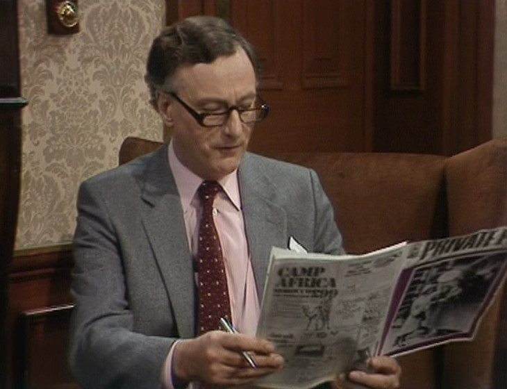 Private Eye issue held in episode, with purple cover
