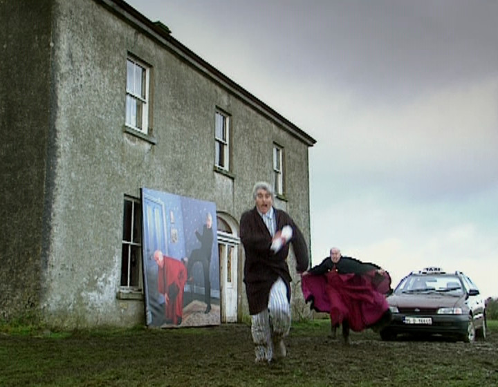 Ted running away from a big picture of him kicking Bishop Brennan up the arse, on location