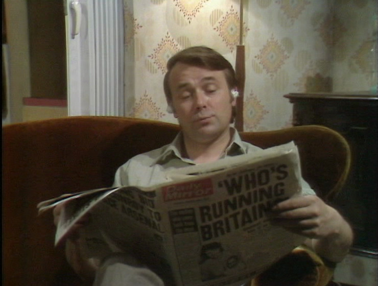 Eddie reading the same copy of the paper by himself, later on