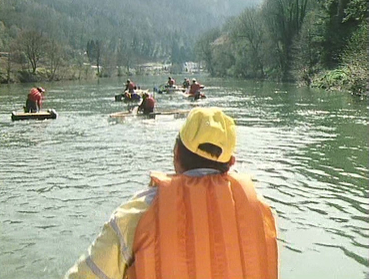 A suspiciously-thin Terry, shown from behind, paddling down the river