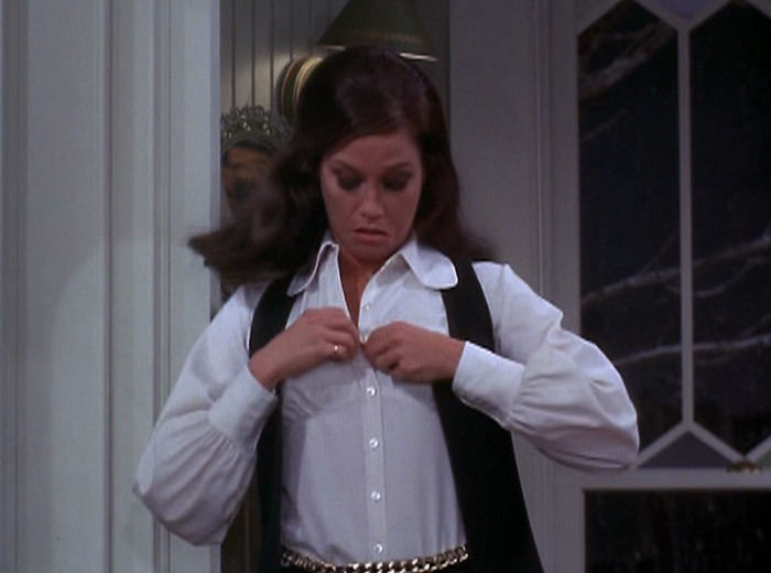 Mary doing up her buttons